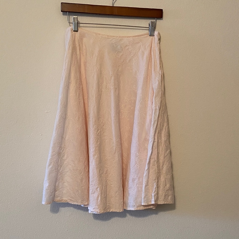 Feminine light pink skirt with flower stitching detail. Caslon size 4.